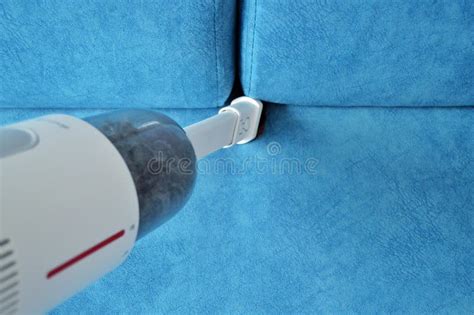 White Handheld Vacuum Cleaner Vacuums the Blue Sofa Stock Image - Image ...