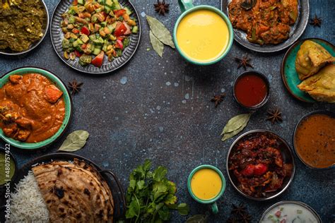 Indian ethnic food buffet on concrete table from above: curry, samosa ...