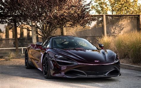 a black sports car is parked on the street