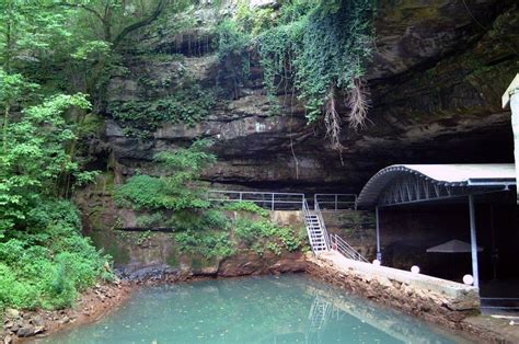 there is a small pool in the middle of this cave with stairs leading up to it