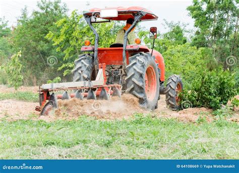 Tractor tilling in field stock image. Image of ploughing - 64108669