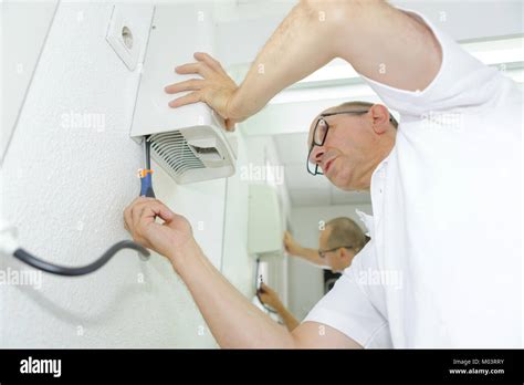 Man installing hand dryer Stock Photo - Alamy