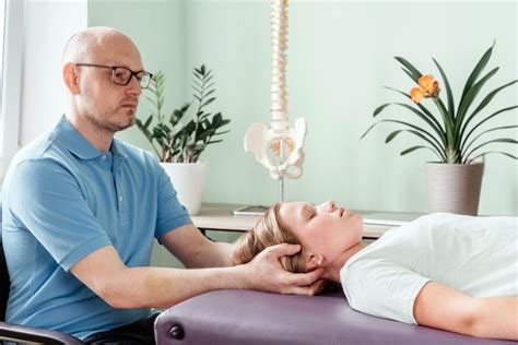 Premium Photo | Massage therapist performing cranial sacral therapy on a female child patient ...