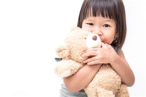 Asian cute little child girl hugging teddy bear isolated on white ...