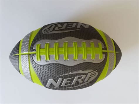 a close up of a gray and yellow ball on a white surface with the word nerf written on it