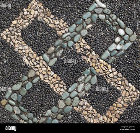 Multi colored pebbles design imbedded in concrete pavement Stock Photo ...