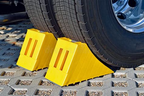 Yellow Chocks at the Wheel of a Parked Truck Stock Image - Image of ...