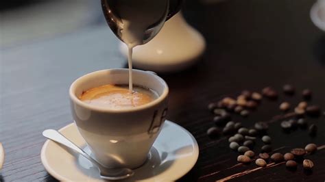 Pouring Milk Into Coffee In Cafe Stock Footage SBV-310291871 - Storyblocks