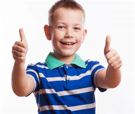 Portrait of happy boy showing thumbs up gesture | Children’s Hearings ...