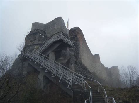 stairs leading up to the top of a castle like structure on a foggy day