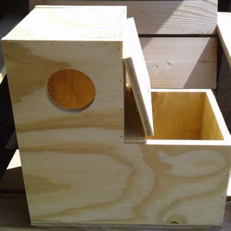 a wooden box with a hole in the middle and two pieces of wood around it