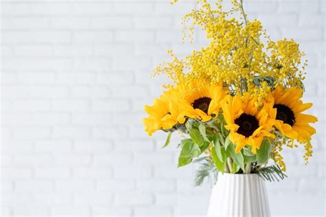 Premium Photo | Blossom of mimosa flowers and sunflowers in white ...