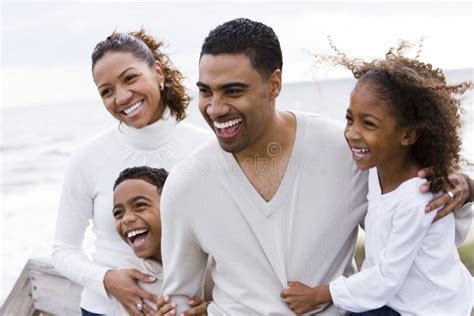 Happy African-American Family of Four on Beach Stock Photo - Image of ...