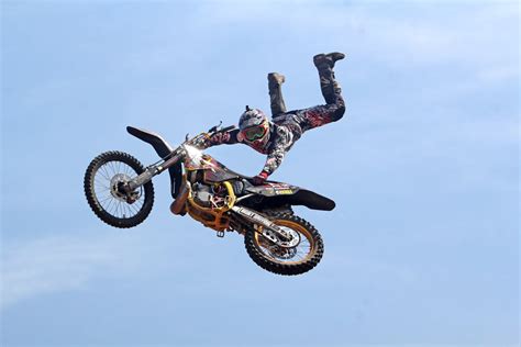 Man Riding Orange Motocross Dirt Bike · Free Stock Photo