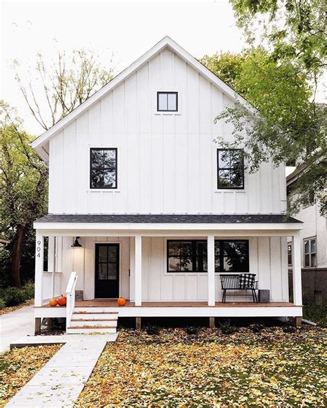 White board and batten vinyl vertical siding, black framed windows, wood deck, metal roof ...