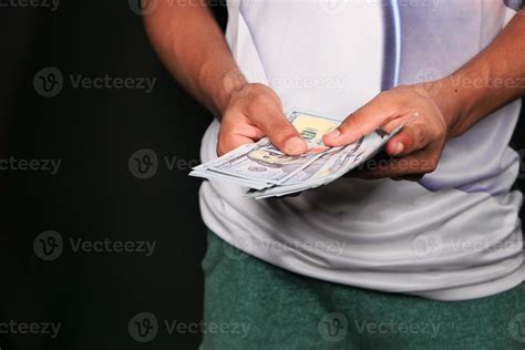 Man counting cash on black background 2174084 Stock Photo at Vecteezy