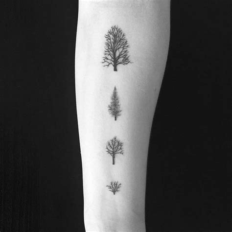 Small tree tattoos on the left inner arm.