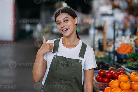 Woman seller at the counter with vegetables. Small business concept ...