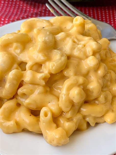 Easy, creamy mac and cheese with evaporated milk on white plate made in slo… | Easy crockpot mac ...