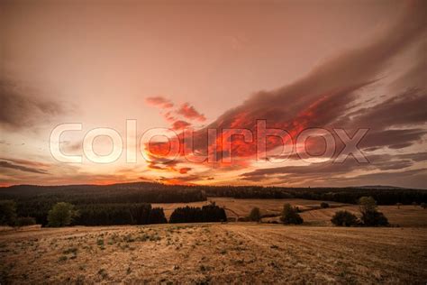 Amazing sunset over dry plains with ... | Stock image | Colourbox