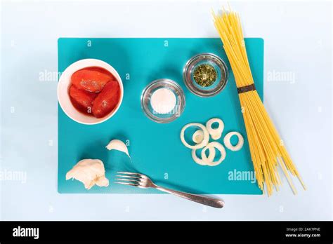 ingredients for preparing spaghetti with tomato sauce Stock Photo - Alamy