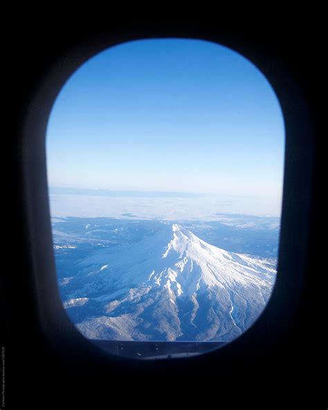 "A View Of A Snow-covered Mount Hood Through An Airplane Window" by ...