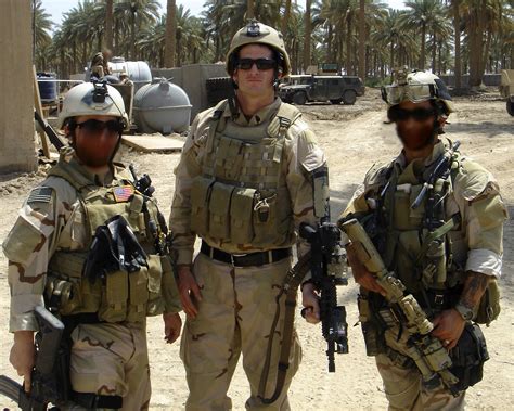 Petty Officer Second Class (SEAL) Michael A. Monsoor (center) poses for a photo with two ...