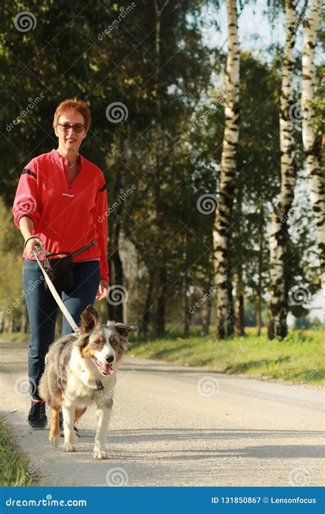 Middle Age Woman Walking Her Dog Stock Image - Image of nature, animal: 131850867