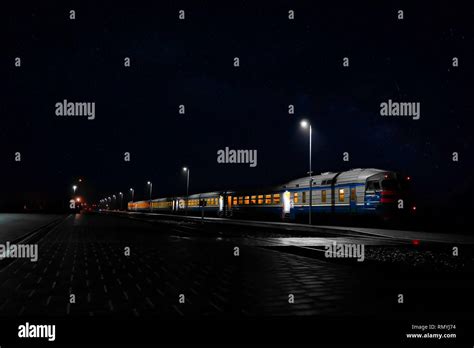 train on the railway platform of the station at night Stock Photo - Alamy