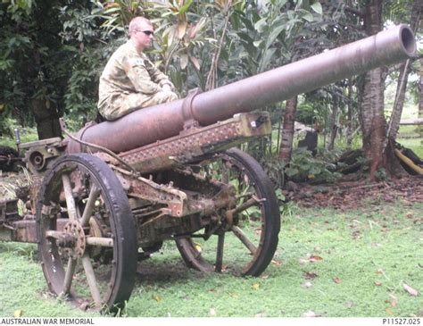 Lance Bombardier Tim Playford sits on a wreck of a Type 96 15cm Howitzer used by the Japanese ...