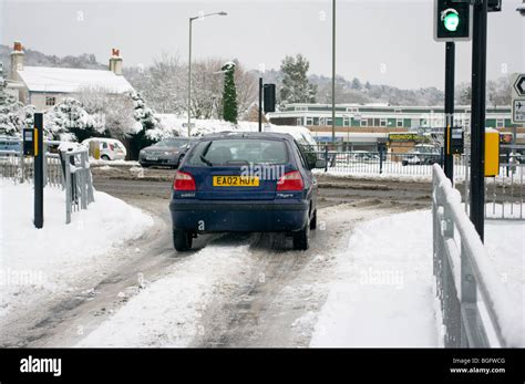 Car Driving Through The Slush And Snow Stock Photo - Alamy