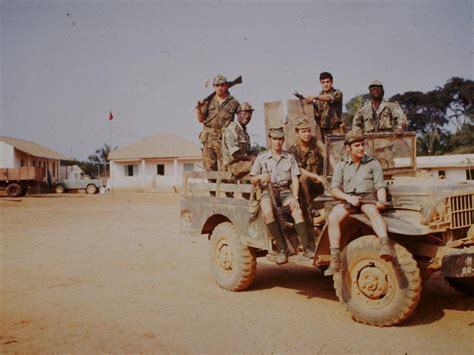 A group of Portuguese soldiers standing in a vehicle in the barracks during the Portuguese ...