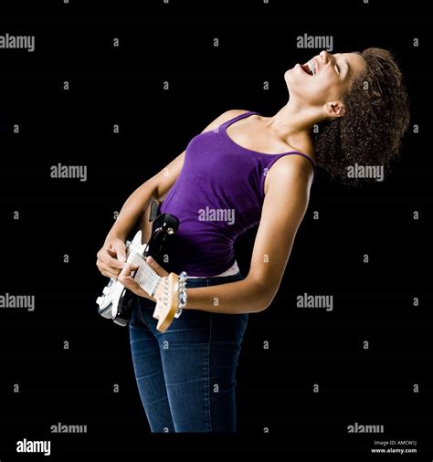 Girl playing electric guitar and singing Stock Photo - Alamy