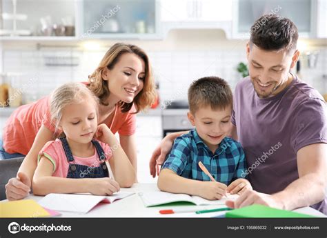 Children with parents doing homework Stock Photo by ©belchonock 195865032