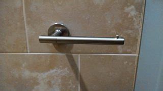 tile - How do I secure a one-armed toilet paper holder, which constantly slips off the mount ...