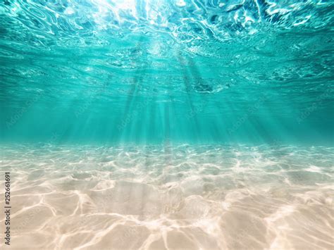 underwater background deep blue sea and beautiful light rays with sandy floor Stock Photo ...