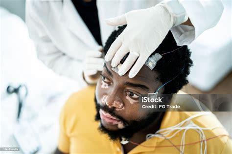 Doctor Placing Electrodes On Patients Head For A Polysomnography Stock Photo - Download Image ...