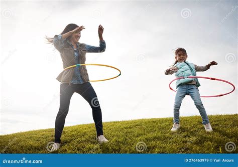 Spinning on the Double. a Little Girl and Her Mom Having a Hula Hoop ...