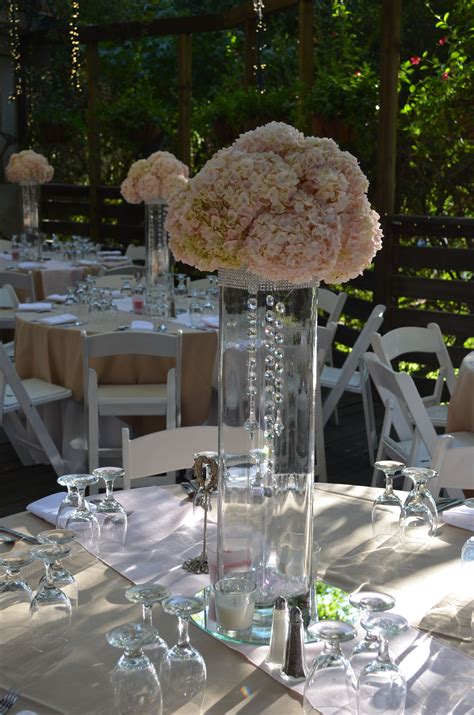 Tall Centerpieces-Clear glass vase with rhinestones hanging with blush fluffy hydrangeas on the ...