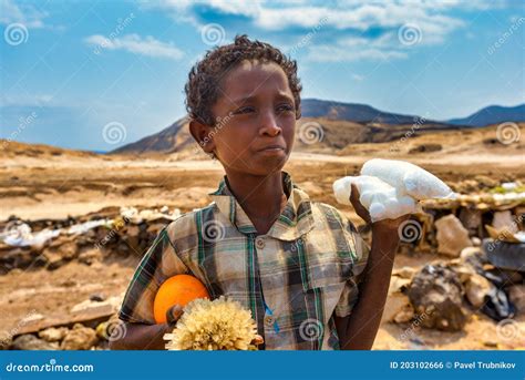 DJIBOUTI,REPUBLIC of DJIBOUTI/FEBRUARY 3,2013:a Boy Sells Crystals of Salt on the Shore of Lake ...