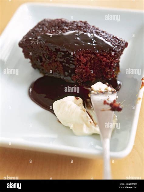 Chocolate sponge pudding with sticky sauce and cream Stock Photo - Alamy