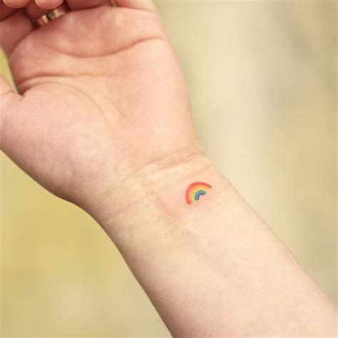 Minimalistic micro rainbow tattoo done on the wrist.