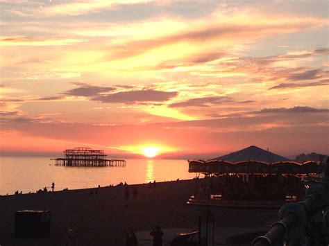 Sunset on Brighton beach with the West Pier in the background ...