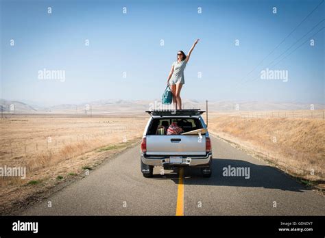 Woman standing on roof car hi-res stock photography and images - Alamy