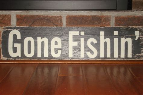 Gone Fishin' sign hand painted on very weathered piece of