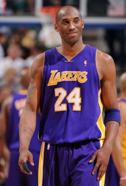 Kobe Bryant smiles in a purple road jersey in Utah.JPG