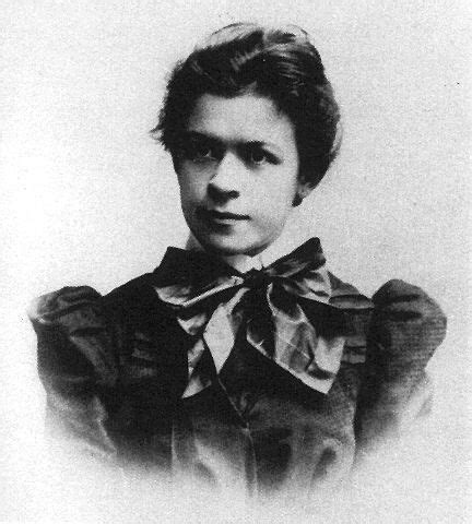 an old black and white photo of a woman wearing a bow tie