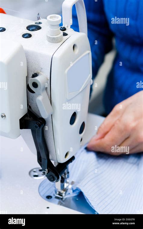 Hands work a sewing machine Stock Photo - Alamy