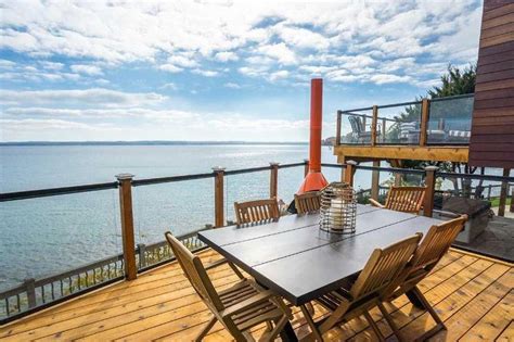 Traverse City waterfront home has jaw-dropping views with decks galore, heated floors, putting ...