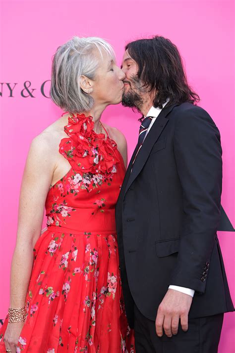 Keanu Reeves kisses Alexandra Grant with eyes open on red carpet